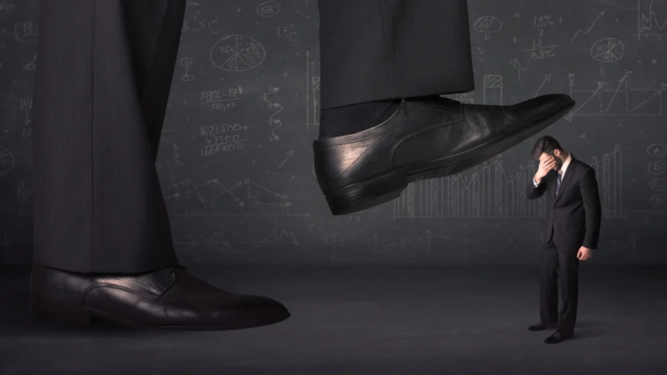 Huge leg stepping on a tiny businnessman concept on background