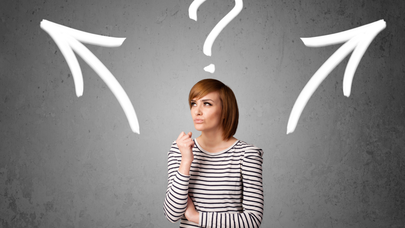 Pretty young woman making a decision with arrows and question mark above her head